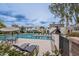 Outdoor community pool with lounge chairs and umbrellas next to lush landscaping at 3823 N 28Th St, Phoenix, AZ 85016