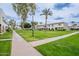 Well-manicured front lawn with mature trees and sidewalks leading to the attractive condo buildings at 3823 N 28Th St, Phoenix, AZ 85016