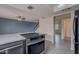 Kitchen featuring an oven, grey tile flooring, and open access to the living room at 3823 N 28Th St, Phoenix, AZ 85016