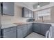 Charming kitchen featuring gray cabinets, a light countertop, and a stainless-steel sink at 3823 N 28Th St, Phoenix, AZ 85016