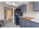 Well-lit kitchen boasting stainless steel appliances, grey cabinets, and neutral-toned countertops at 3823 N 28Th St, Phoenix, AZ 85016