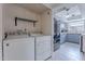 Laundry room with washer, dryer, shelf, and an open view to the kitchen at 3823 N 28Th St, Phoenix, AZ 85016