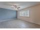 Comfortable living room featuring tile flooring, a ceiling fan, and window with plantation shutters at 3823 N 28Th St, Phoenix, AZ 85016