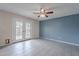 Bright living room with tiled floors, ceiling fan, and French doors leading to the outside at 3823 N 28Th St, Phoenix, AZ 85016