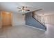 Open-concept living room featuring tile flooring, a ceiling fan, and staircase at 3823 N 28Th St, Phoenix, AZ 85016