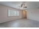 Open living room features tiled floors, a ceiling fan, and large window shutters at 3823 N 28Th St, Phoenix, AZ 85016