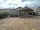 View of the backyard from a distance, showcasing the covered patio and potential for landscaping at 4050 E Agave Rd, Phoenix, AZ 85044