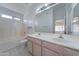 Bright bathroom featuring double sinks, vanity, and a tub with shower at 4050 E Agave Rd, Phoenix, AZ 85044