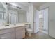 A cozy bathroom featuring a vanity with a sink and mirror, toilet, and tile flooring at 4050 E Agave Rd, Phoenix, AZ 85044