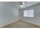 Comfortable bedroom with window and ceiling fan at 4050 E Agave Rd, Phoenix, AZ 85044