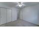 Bright bedroom with closet, ceiling fan, and neutral carpet at 4050 E Agave Rd, Phoenix, AZ 85044