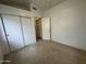 Bedroom featuring neutral carpet and closet with sliding doors at 4050 E Agave Rd, Phoenix, AZ 85044