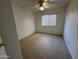 This bedroom features neutral carpet, a ceiling fan, and a window with blinds at 4050 E Agave Rd, Phoenix, AZ 85044