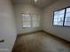 Cozy bedroom featuring neutral carpet and natural light from window at 4050 E Agave Rd, Phoenix, AZ 85044