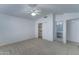 Carpeted bedroom with ceiling fan, closet and attached bathroom at 4050 E Agave Rd, Phoenix, AZ 85044