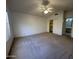 Spacious carpeted bedroom with ceiling fan, closet, and access to a bathroom at 4050 E Agave Rd, Phoenix, AZ 85044