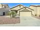 Beige single-story home featuring low maintenance landscaping and a two car garage at 4050 E Agave Rd, Phoenix, AZ 85044