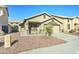 Beige single-story home featuring low maintenance landscaping and a two car garage at 4050 E Agave Rd, Phoenix, AZ 85044