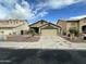 Charming single Gathering home featuring desert landscaping, two-car garage, and neutral earth-tone color scheme at 4050 E Agave Rd, Phoenix, AZ 85044