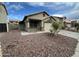 Charming single Gathering home featuring desert landscaping, two-car garage, and neutral earth-tone color scheme at 4050 E Agave Rd, Phoenix, AZ 85044