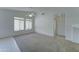 Bright living room with neutral carpet, large windows and a ceiling fan at 4050 E Agave Rd, Phoenix, AZ 85044