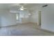 Spacious living room featuring neutral carpet, ceiling fan, and great natural light at 4050 E Agave Rd, Phoenix, AZ 85044