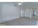 Open living room with neutral carpet, white walls, and open access to kitchen at 4050 E Agave Rd, Phoenix, AZ 85044