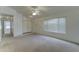 Spacious living room featuring neutral carpet, ceiling fan, and great natural light at 4050 E Agave Rd, Phoenix, AZ 85044