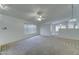 Spacious living room featuring neutral carpet, ceiling fan, and great natural light at 4050 E Agave Rd, Phoenix, AZ 85044