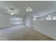 Spacious living room featuring neutral carpet, ceiling fan, and great natural light at 4050 E Agave Rd, Phoenix, AZ 85044