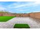 Large backyard with artificial turf, stone pavers, and a wall providing privacy at 4135 E Sagebrush St, Gilbert, AZ 85296