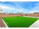 Wide backyard with green turf, paver patio, block wall, and mountain views at 4135 E Sagebrush St, Gilbert, AZ 85296