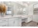 Elegant bathroom with double vanities, white cabinets, and a large mirror at 4135 E Sagebrush St, Gilbert, AZ 85296