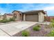 Home exterior featuring a two-car garage, stone accents, manicured landscaping, and visible house number at 4135 E Sagebrush St, Gilbert, AZ 85296