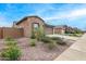 Well-maintained house showcasing desert landscaping, a stone facade, and a tidy neighborhood street at 4135 E Sagebrush St, Gilbert, AZ 85296