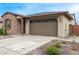 Home exterior featuring a two-car garage, stone accents, manicured landscaping, and visible house number at 4135 E Sagebrush St, Gilbert, AZ 85296