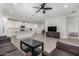 Spacious living room with modern flooring, ceiling fan, and furniture, adjacent to a well-lit kitchen area at 4135 E Sagebrush St, Gilbert, AZ 85296