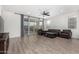 Bright living room featuring modern flooring, a ceiling fan, and sliding glass doors to the backyard at 4135 E Sagebrush St, Gilbert, AZ 85296