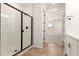 This bathroom features a shower, vanity, and a view of the bedroom at 5352 W Las Palmaritas Dr, Glendale, AZ 85302