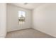 This is a bedroom with a window, neutral carpet, and light walls at 5352 W Las Palmaritas Dr, Glendale, AZ 85302