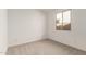 Bright bedroom with neutral carpet and a window at 5352 W Las Palmaritas Dr, Glendale, AZ 85302