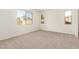 A bright bedroom with three windows and neutral carpet at 5352 W Las Palmaritas Dr, Glendale, AZ 85302