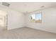 Large bedroom with neutral carpet and a large window at 5352 W Las Palmaritas Dr, Glendale, AZ 85302