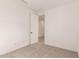 Neutral bedroom featuring carpeted floors, white walls, and an open door at 5352 W Las Palmaritas Dr, Glendale, AZ 85302