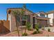 Charming front exterior with desert landscaping, shuttered windows, and a stone-accented, two-car garage at 5352 W Las Palmaritas Dr, Glendale, AZ 85302