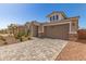 Charming single-Gathering home boasting a two-car garage, stone accents, and well-maintained front yard landscaping at 5352 W Las Palmaritas Dr, Glendale, AZ 85302