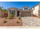 Attractive single-Gathering home featuring a paved driveway, stone accents, and desert-friendly landscaping at 5352 W Las Palmaritas Dr, Glendale, AZ 85302