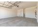 This is a spacious garage featuring a water heater and garage door at 5352 W Las Palmaritas Dr, Glendale, AZ 85302