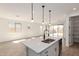 Bright kitchen with a center island, stainless steel appliances, and an open floorplan leading to the backyard at 5352 W Las Palmaritas Dr, Glendale, AZ 85302