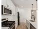 This kitchen features stainless steel appliances, white cabinets and countertops, and modern pendant lighting at 5352 W Las Palmaritas Dr, Glendale, AZ 85302